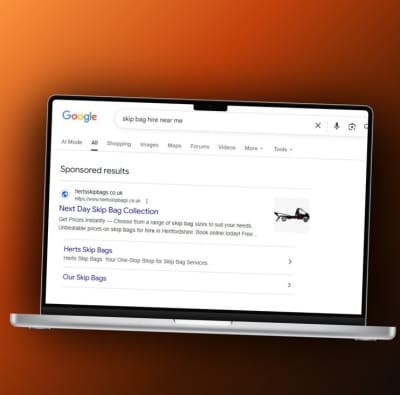 Google search results page displayed on a laptop screen, showing a sponsored ad for Next Day Skip Bag Collection